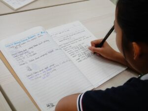 student taking english notes in primary math