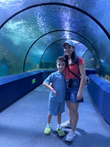 teacher and kid at aquarium
