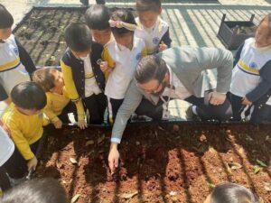 Teacher with students in school garden