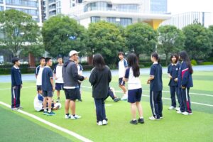 BASIS International & Bilingual Schools coaches with students