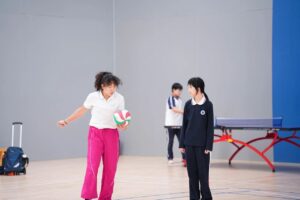 BASIS International & Bilingual Schools coaches with students