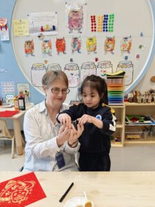 Jeni Nelson. Head of ECE at BASIS Bilingual School Guangming Shenzhen with student